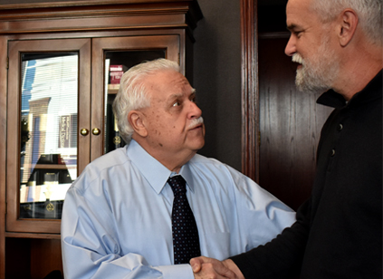 Two Colleagues shaking hands at the law offices in Kansas City